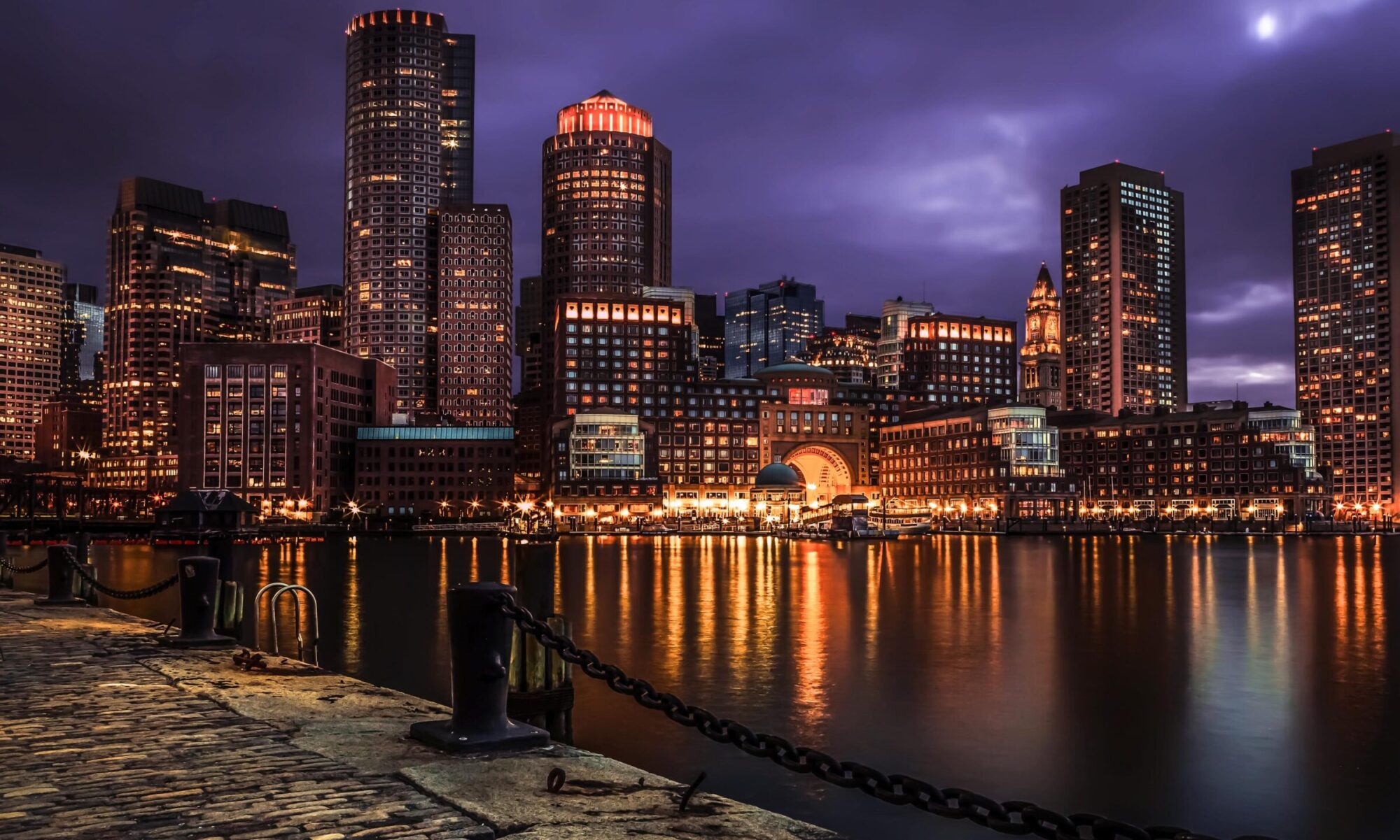 Image of Boston Skyline, over the water at night.